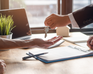 Realtor and Mortgage lender handing the keys to the buyer